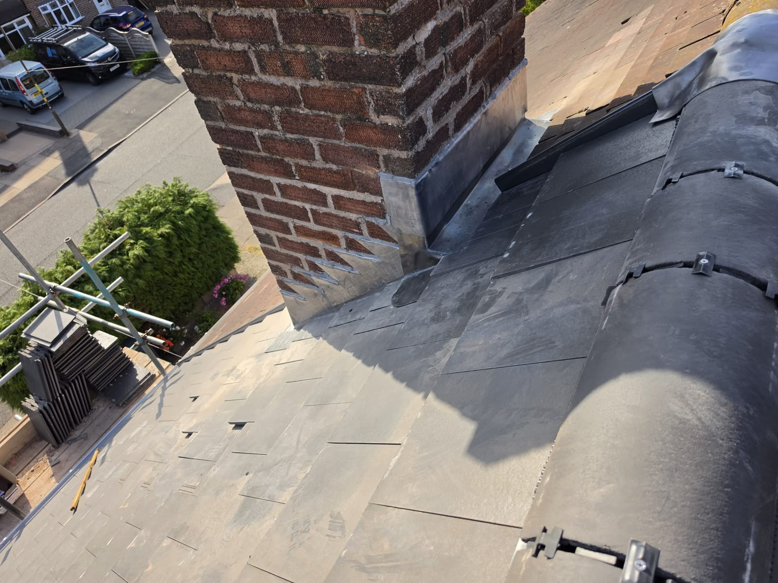 Roof repair and lead flashing around a brick chimney
